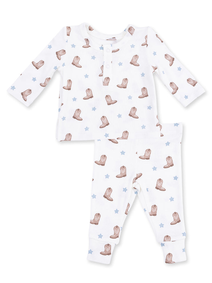 Cotton baby pajama set featuring an all-over cowboy boot and star pattern in neutral colors.