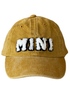 Yellow cap with "MINI" text in fluffy white and black letters on the front.
