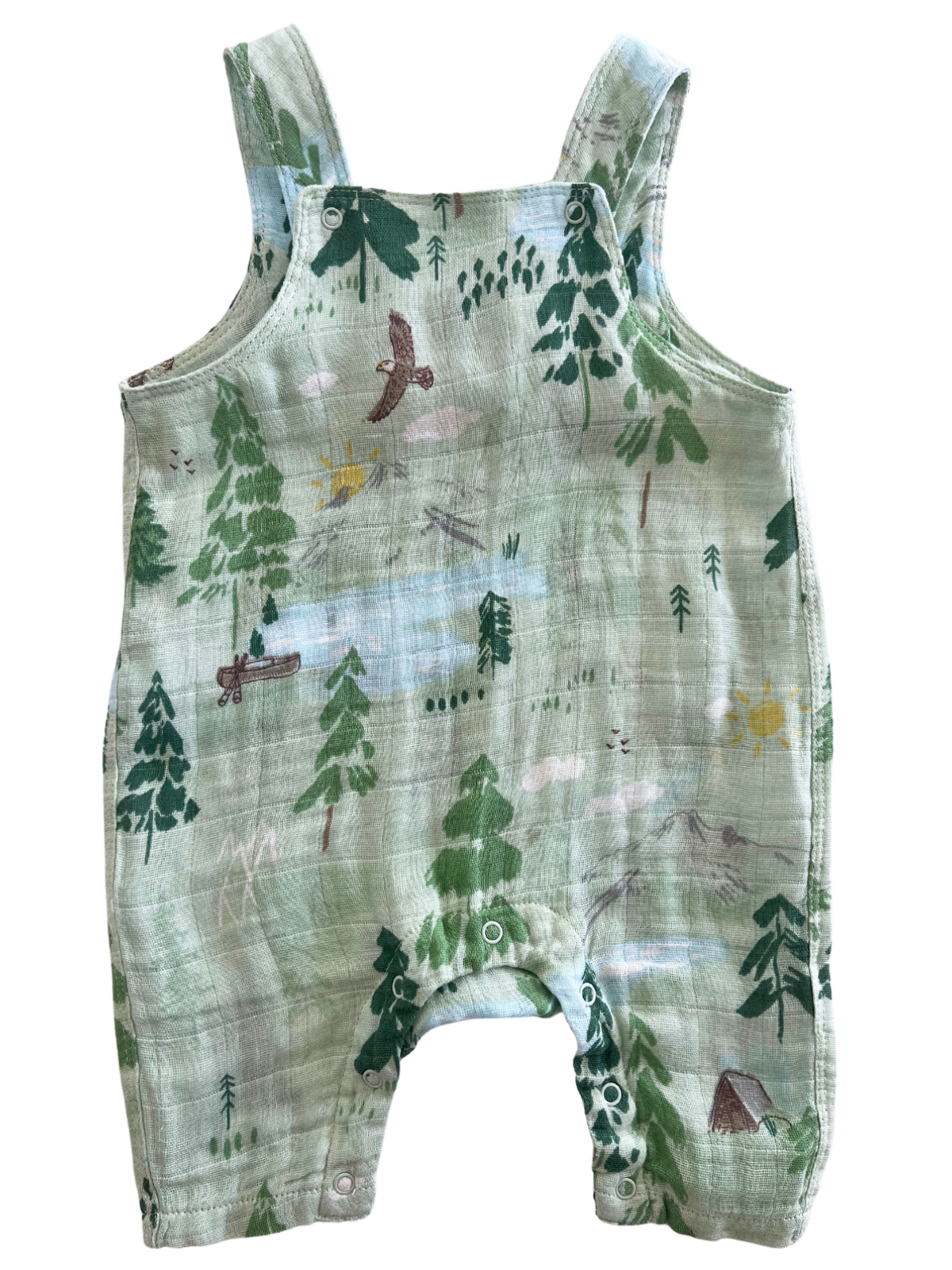 Green baby romper with woodland animal print featuring trees, birds, and a sun on a soft fabric background.