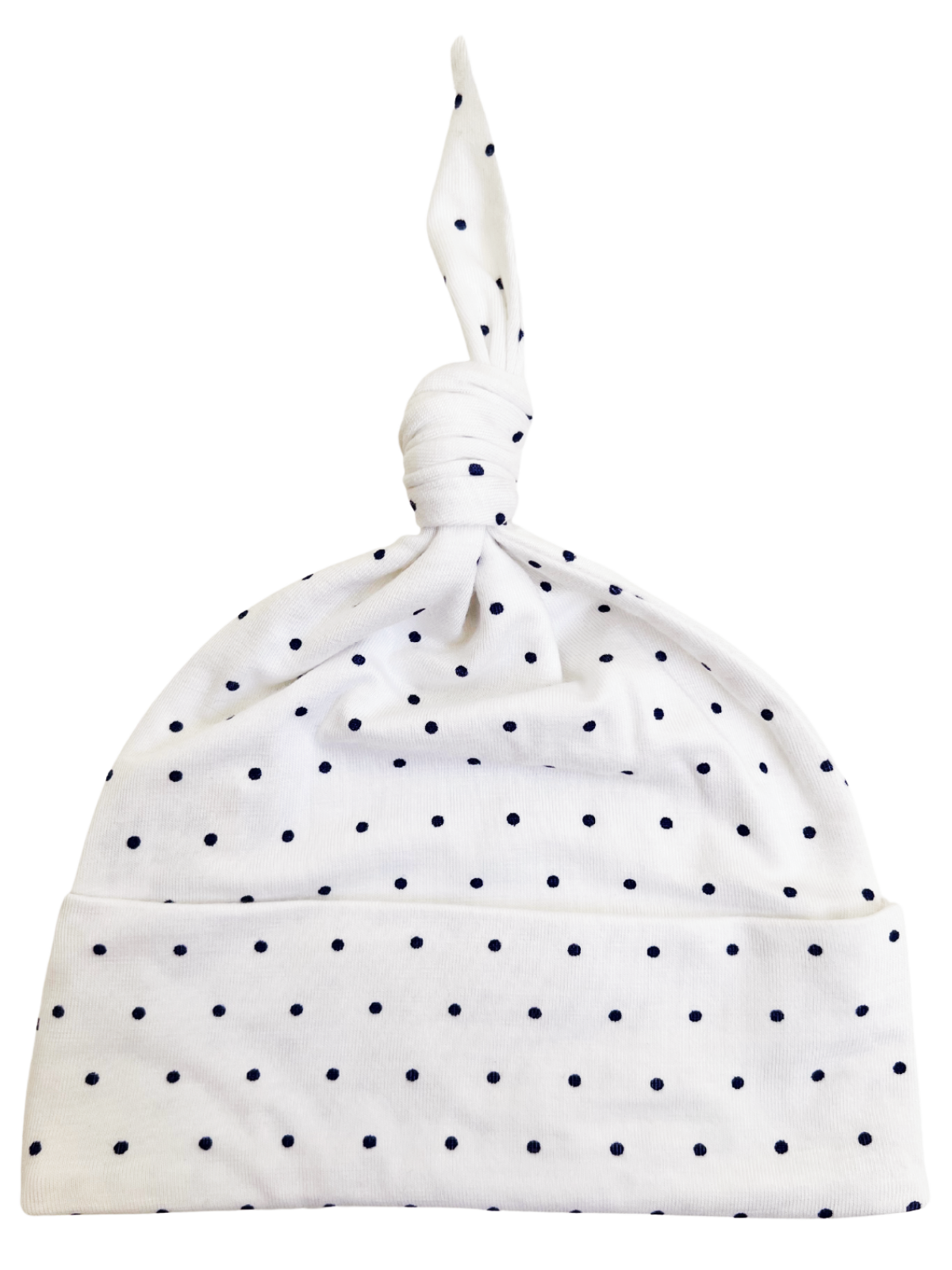 White baby hat with navy polka dots and a knot at the top, suitable for infants.