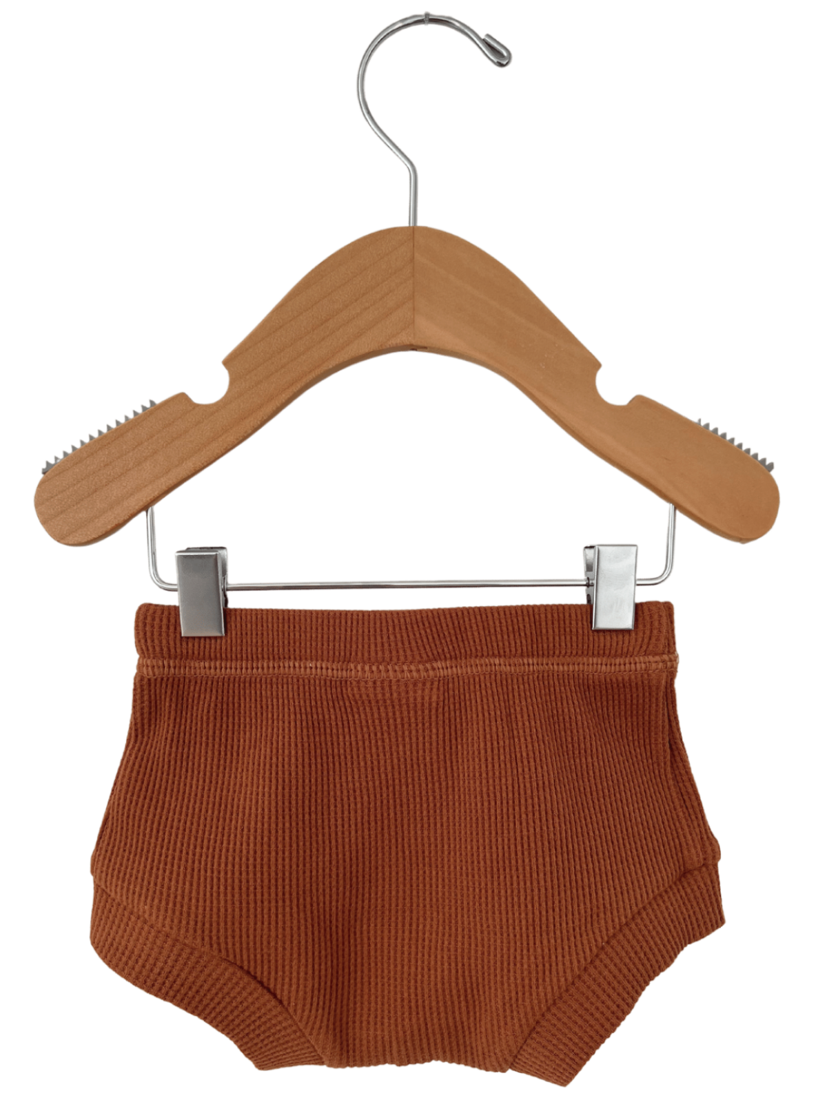 Rust-colored ribbed boyshorts hanging on a wooden hanger against a white background.
