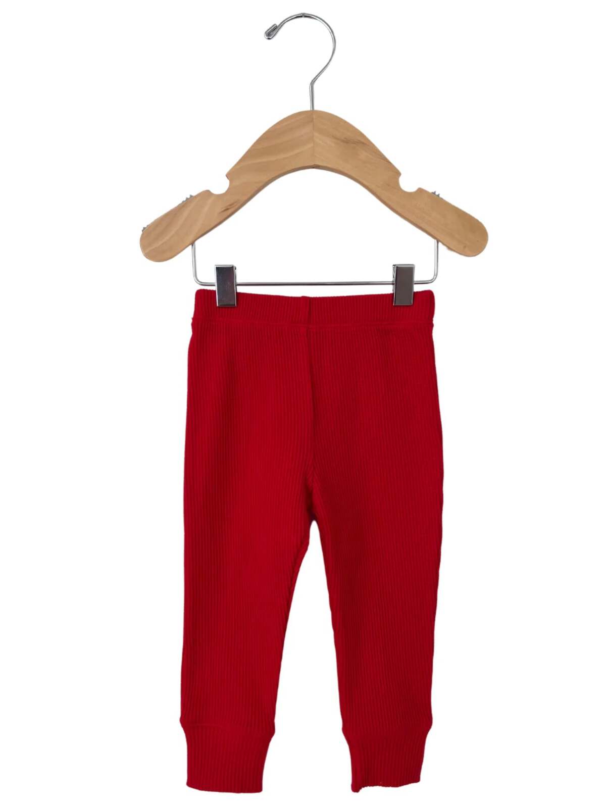 Red ribbed baby leggings hanging on a wooden hanger against a white background.