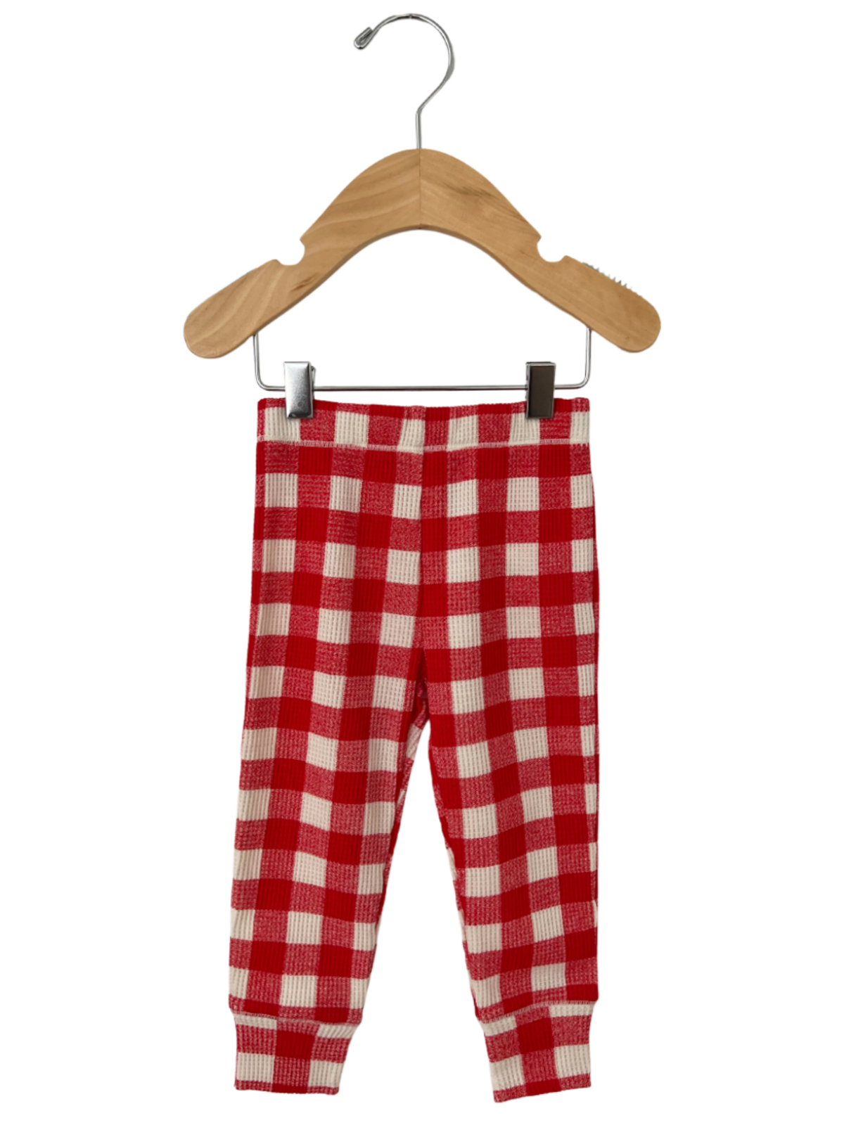 Red and white checkered toddler pants hanging on a wooden hanger.
