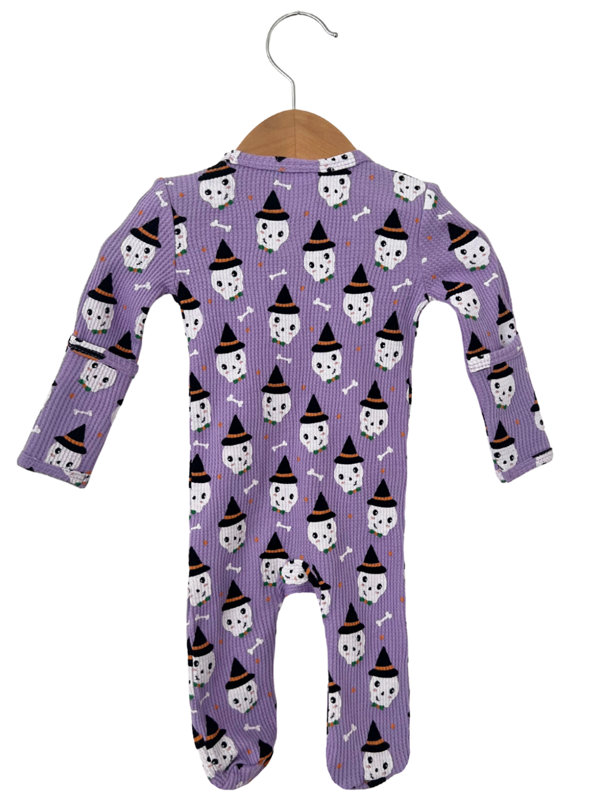Purple toddler onesie with Halloween ghost and witch hat pattern, hanging on a wooden hanger.