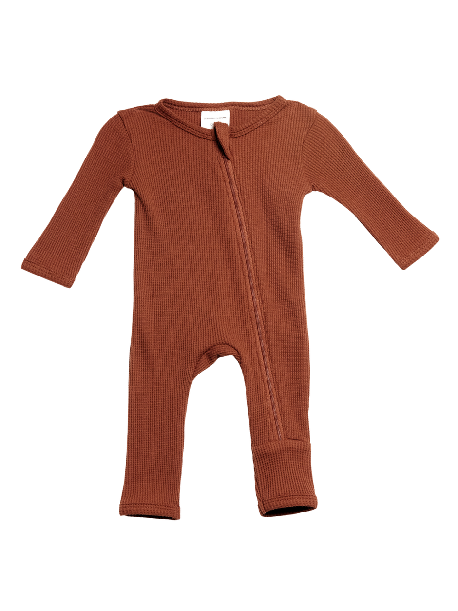 Brown ribbed baby onesie with a front zipper and long sleeves on a white background.