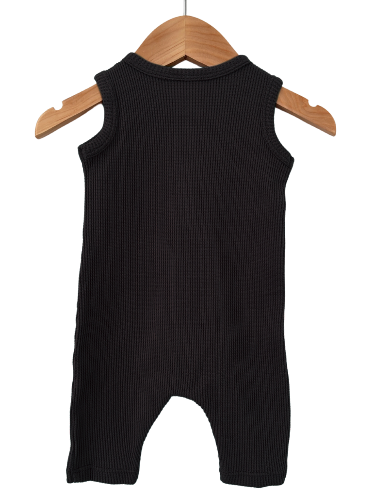 Black sleeveless ribbed baby romper hanging on a wooden hanger against a white background.