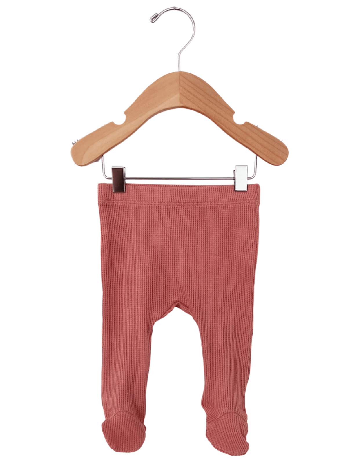 Pink ribbed toddler tights hanging on a wooden hanger.