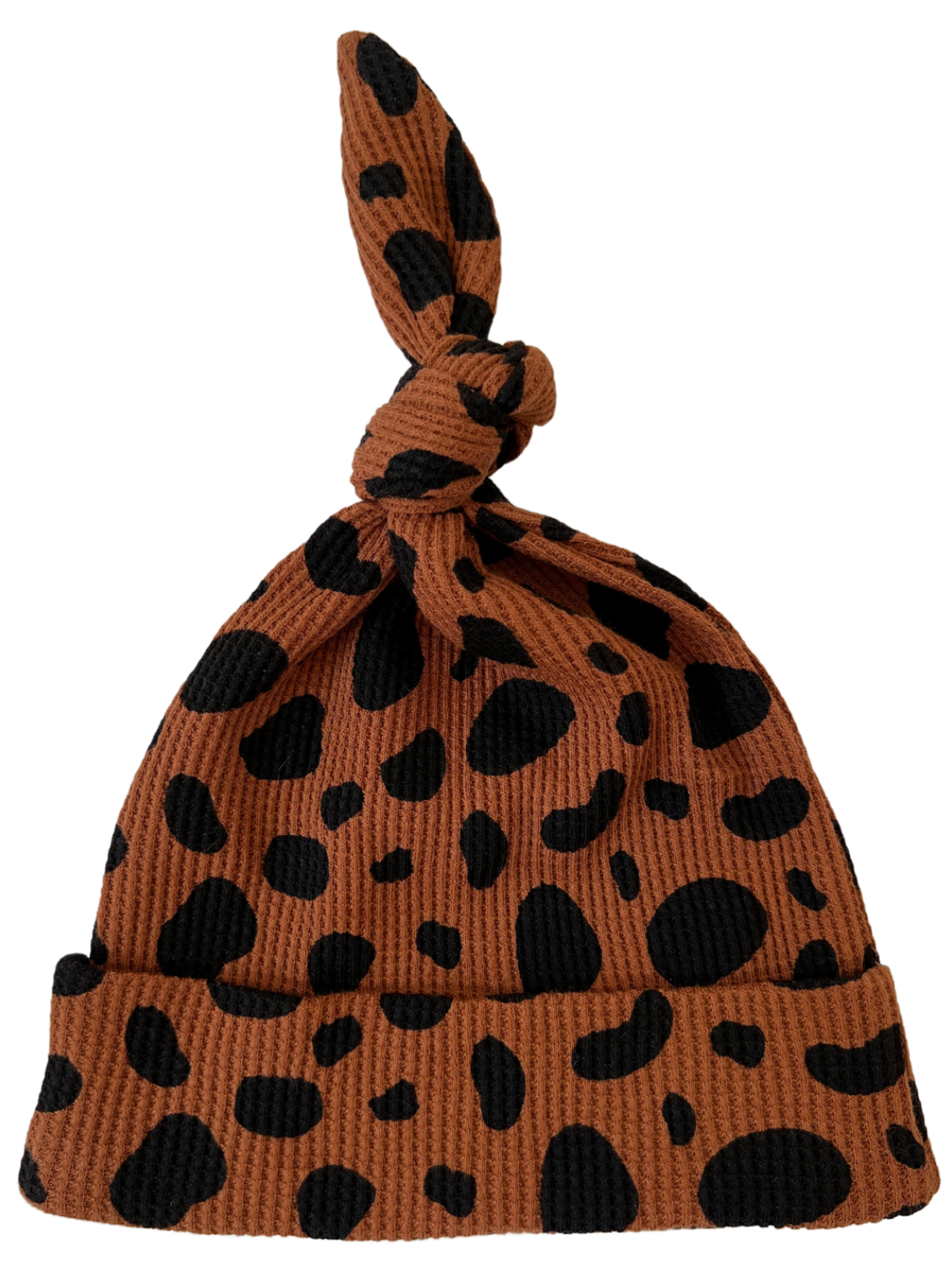 Brown hat with black spots and a knot on top, featuring a ribbed texture.