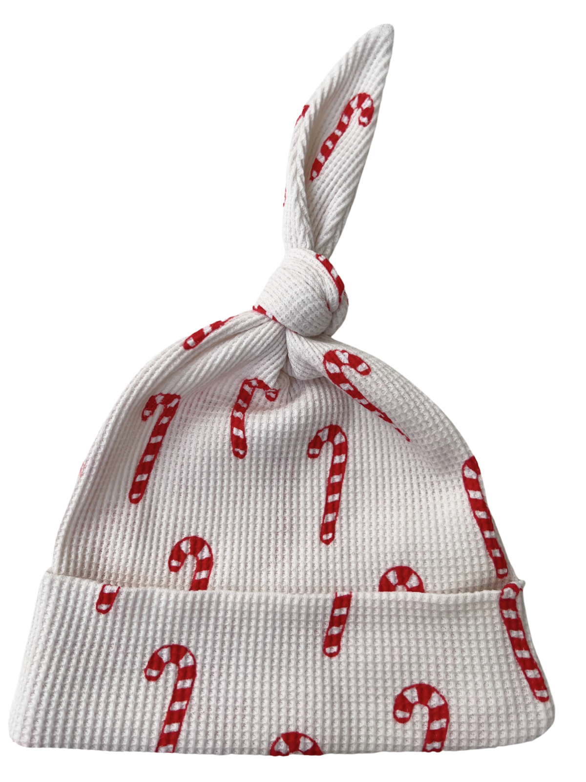 White baby hat with candy cane pattern and a knotted top. Perfect for winter festivities.