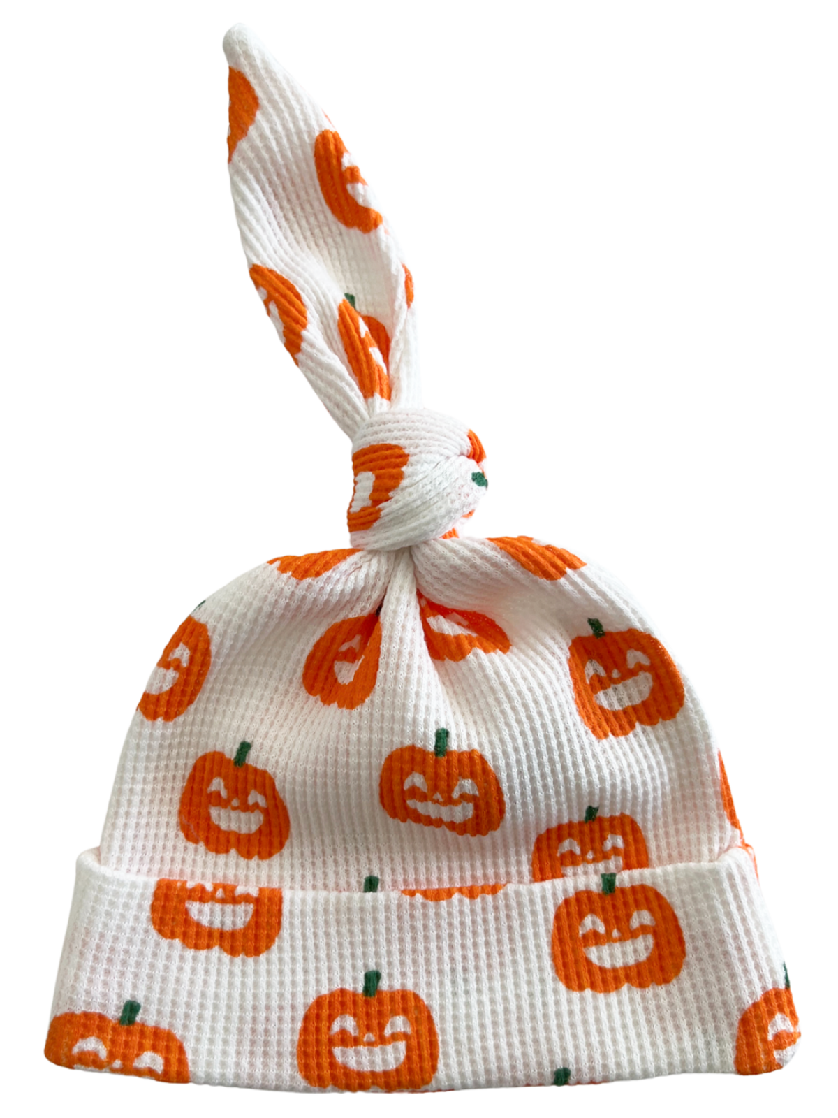 White baby hat with orange pumpkin patterns and a knot at the top, perfect for Halloween.