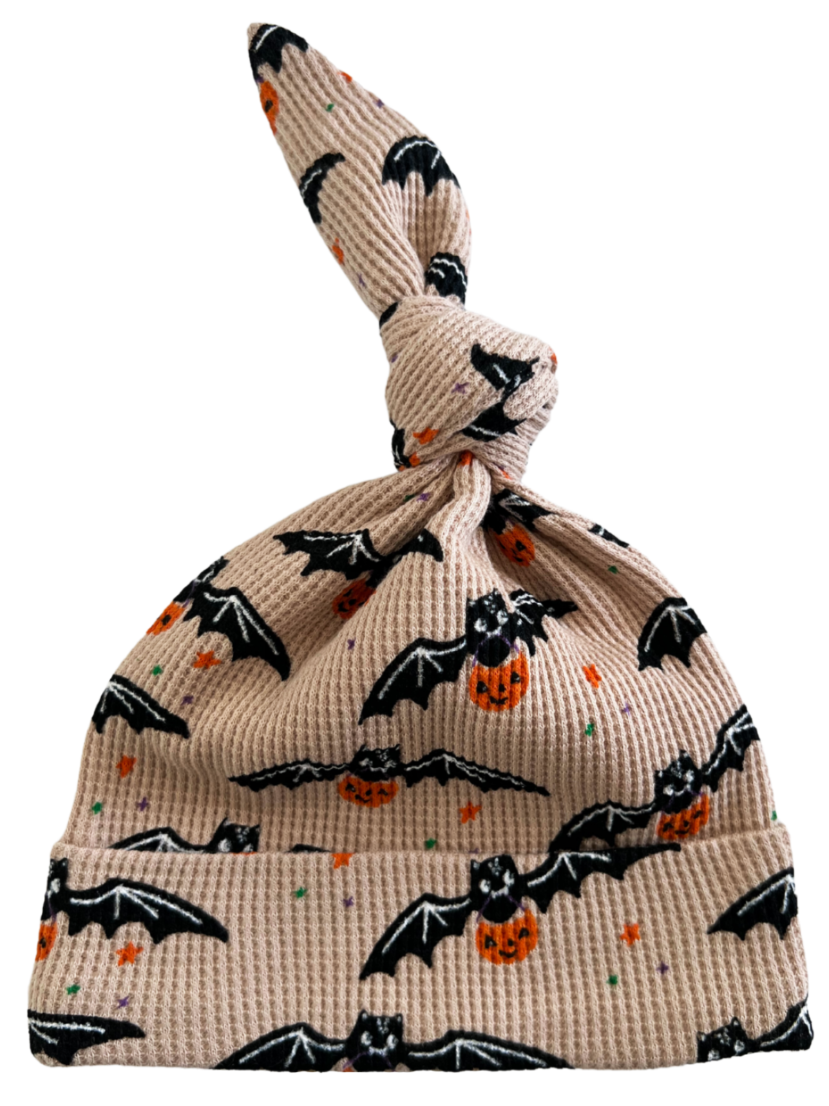 Knotted baby hat with bats and pumpkins on a light background, perfect for Halloween-themed outfits.