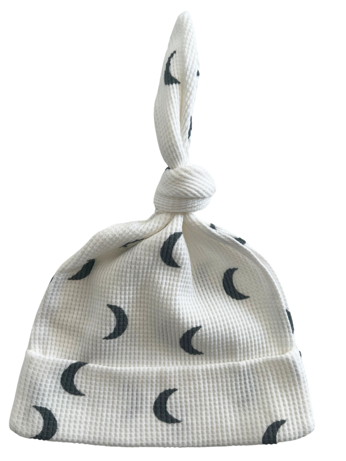 White hat with moon print and a knot on top, perfect for infants or young children.