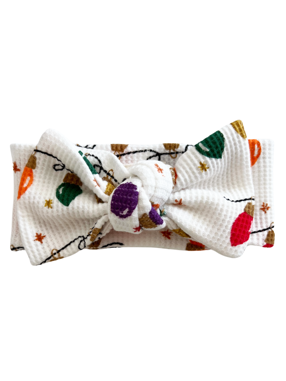White headband with a knot, featuring colorful holiday lights pattern and stars.