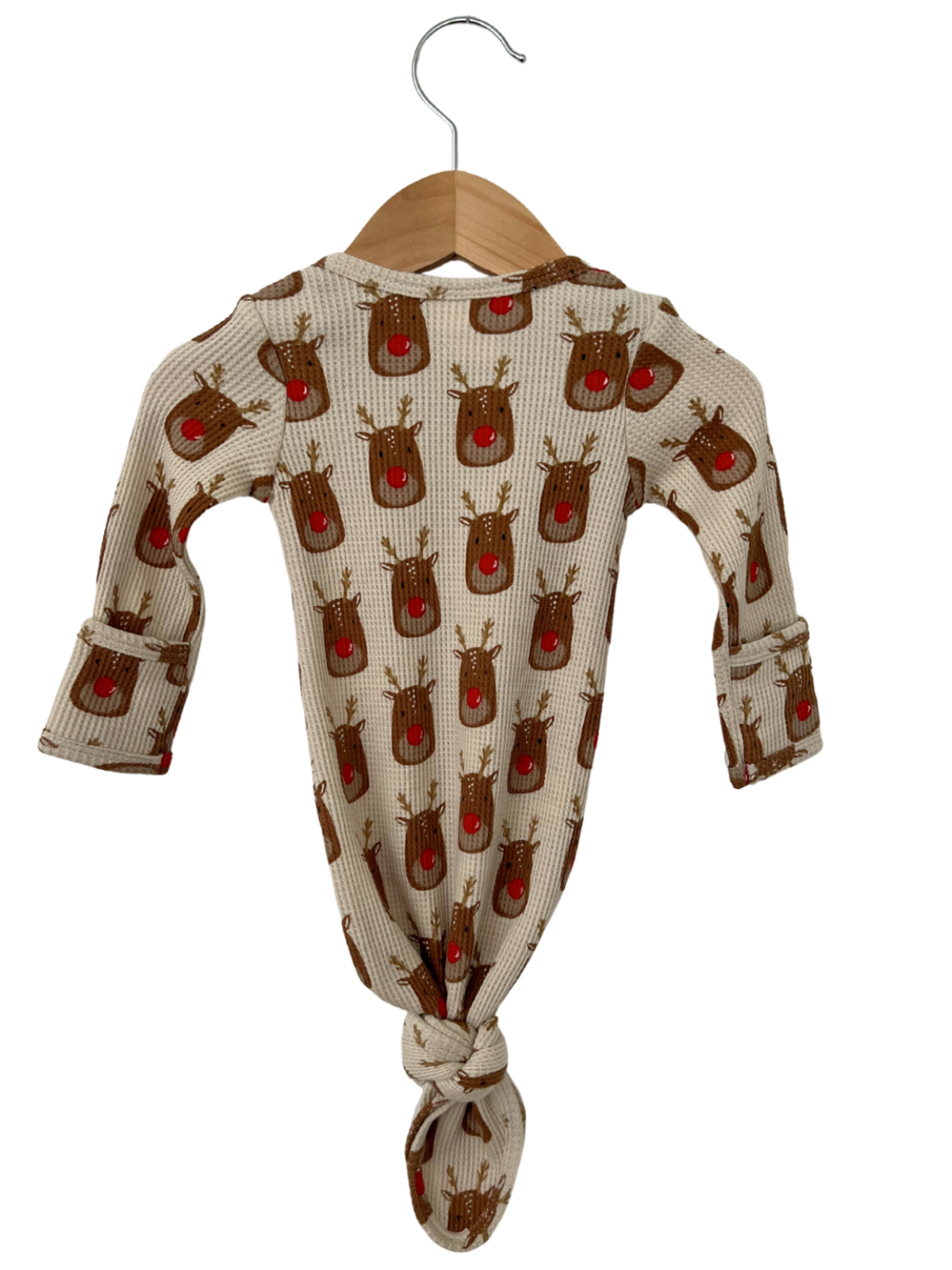 Baby romper with reindeer print, knotted hem, and hanging on a wooden hanger against a white background.