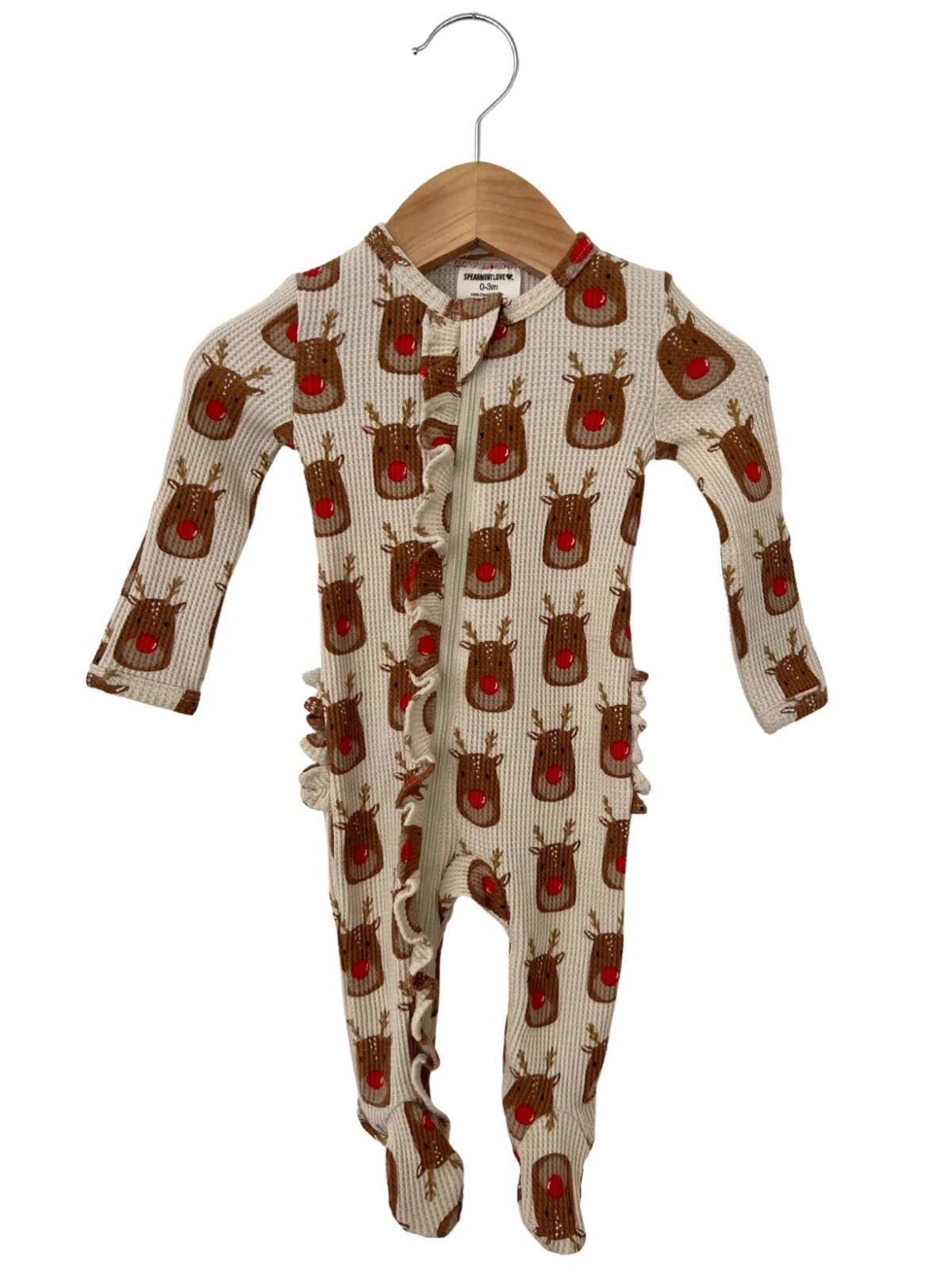 Christmas-themed baby onesie with reindeer pattern and ruffle details, hanging on a wooden hanger.