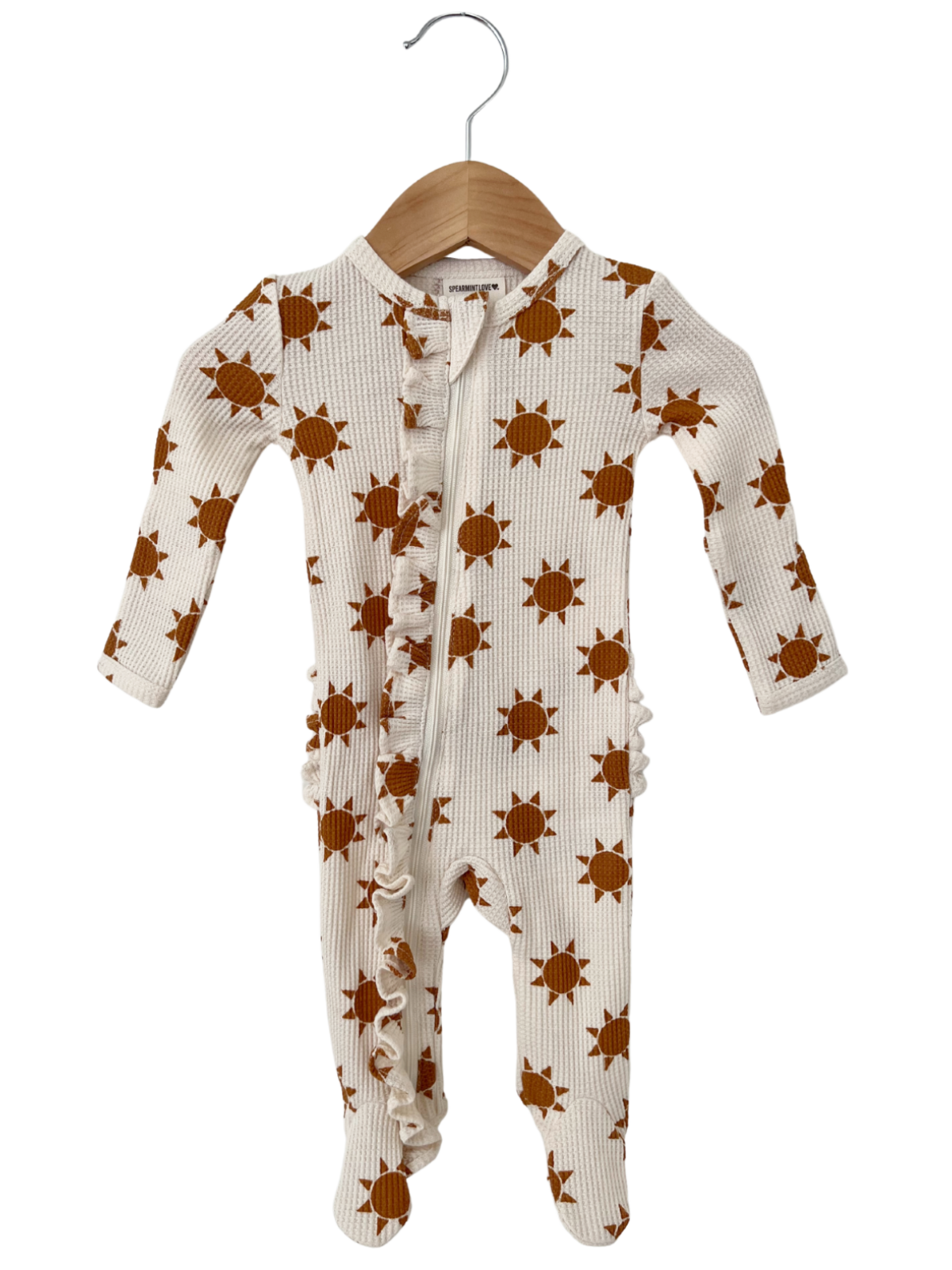 Brown sun-patterned baby onesie on a wooden hanger against a white background.