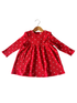 Red dress with long sleeves and white heart patterns, hanging on a wooden hanger.