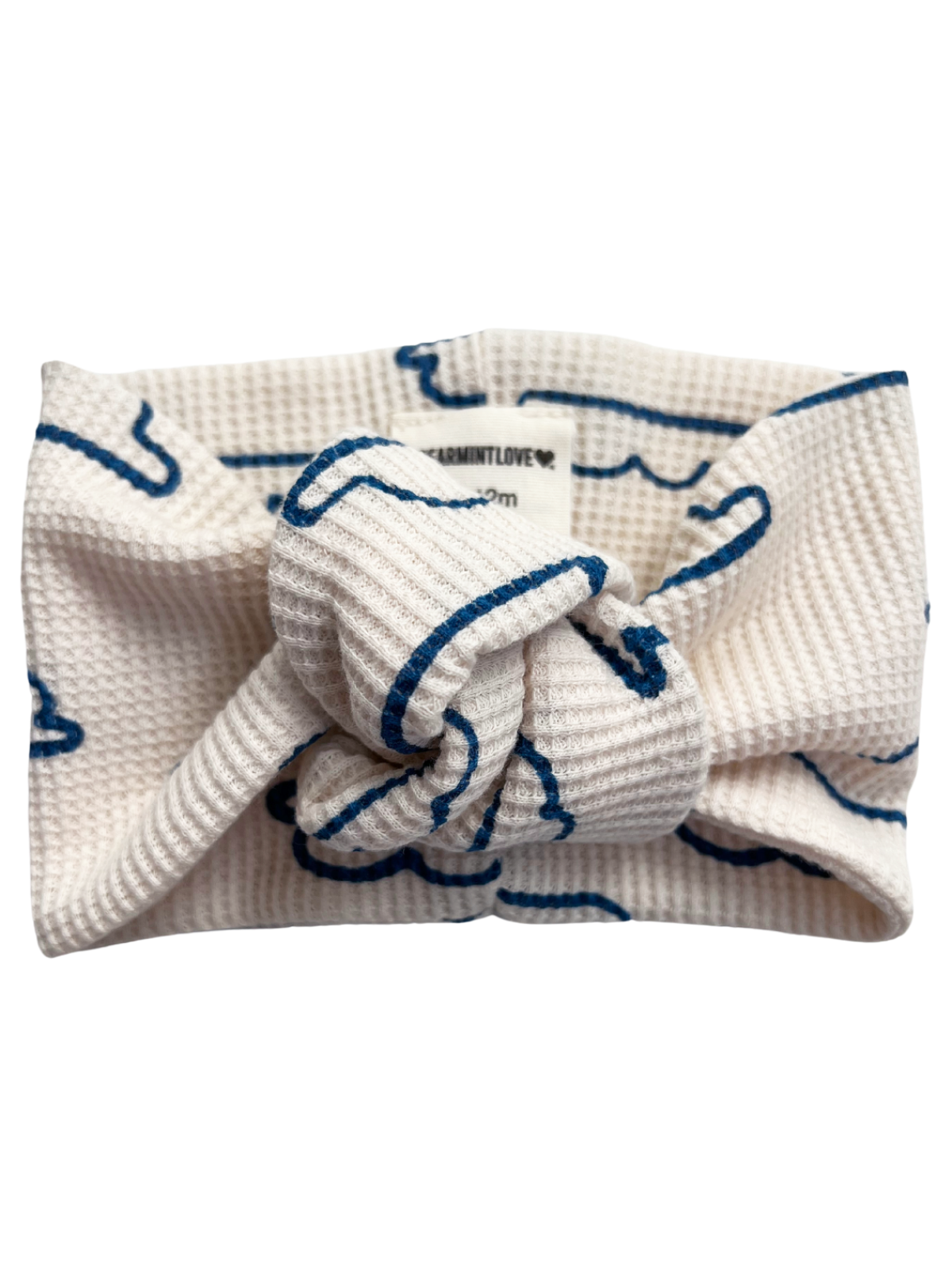 White headband with blue design, featuring a knot at the front, labeled "Fermint Love."