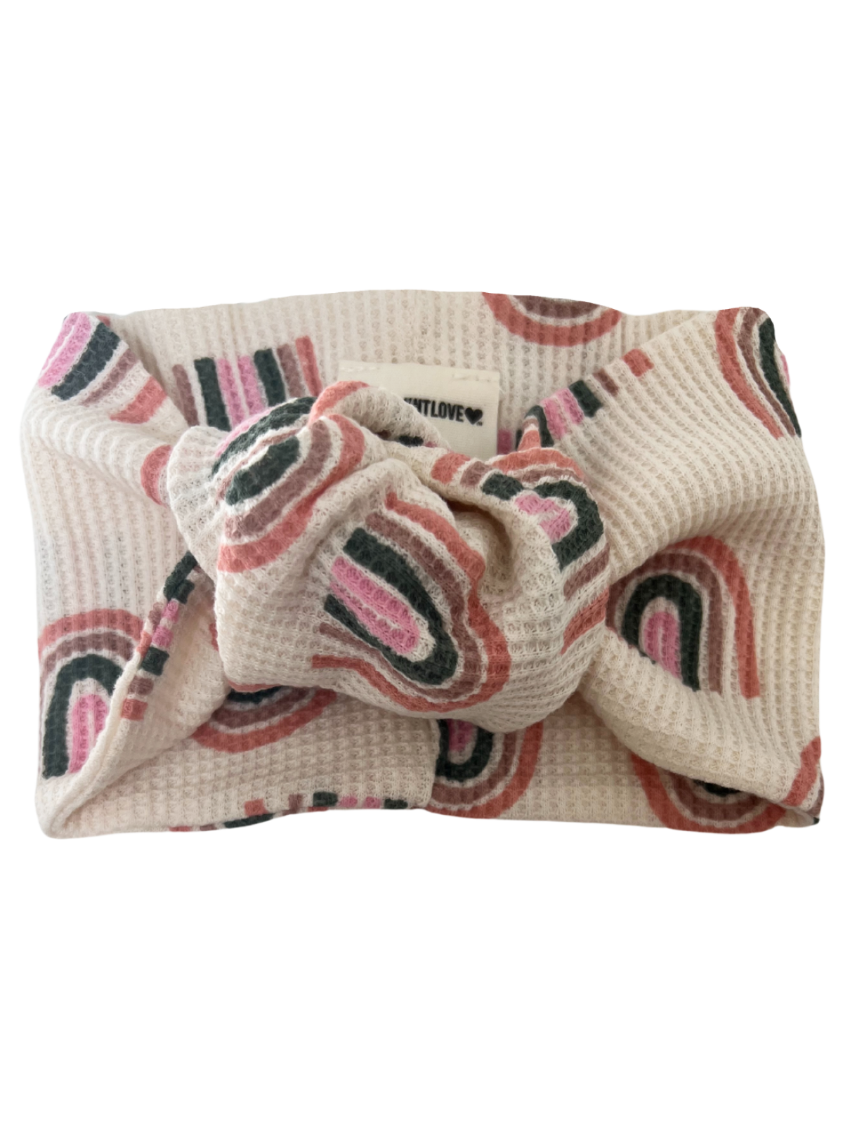 Knotted headband in cream with abstract pink and green patterns, perfect for stylish hair accessories.