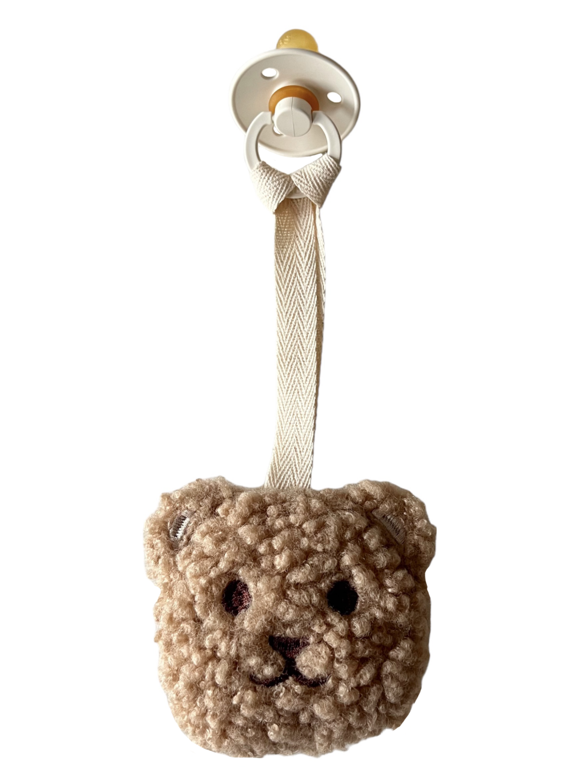 Beige teddy bear pacifier holder with a soft, textured face and a white clip strap.