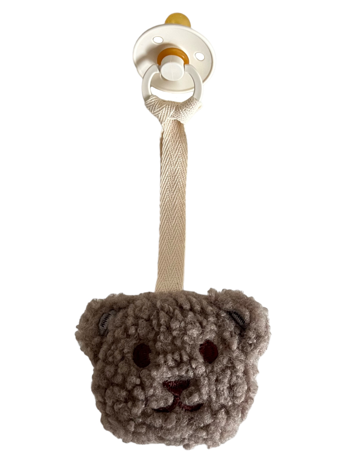 Crochet teddy bear pacifier clip with a soft teddy bear head and a strap for easy attachment.