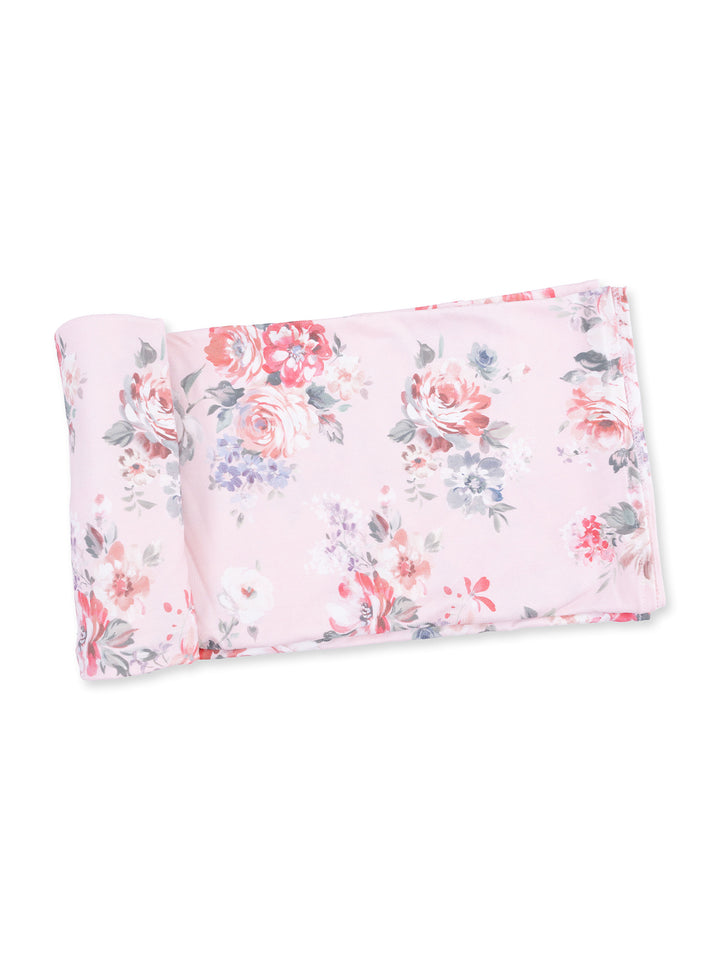 Floral-patterned fabric with pink background, featuring roses and small flowers in various colors.