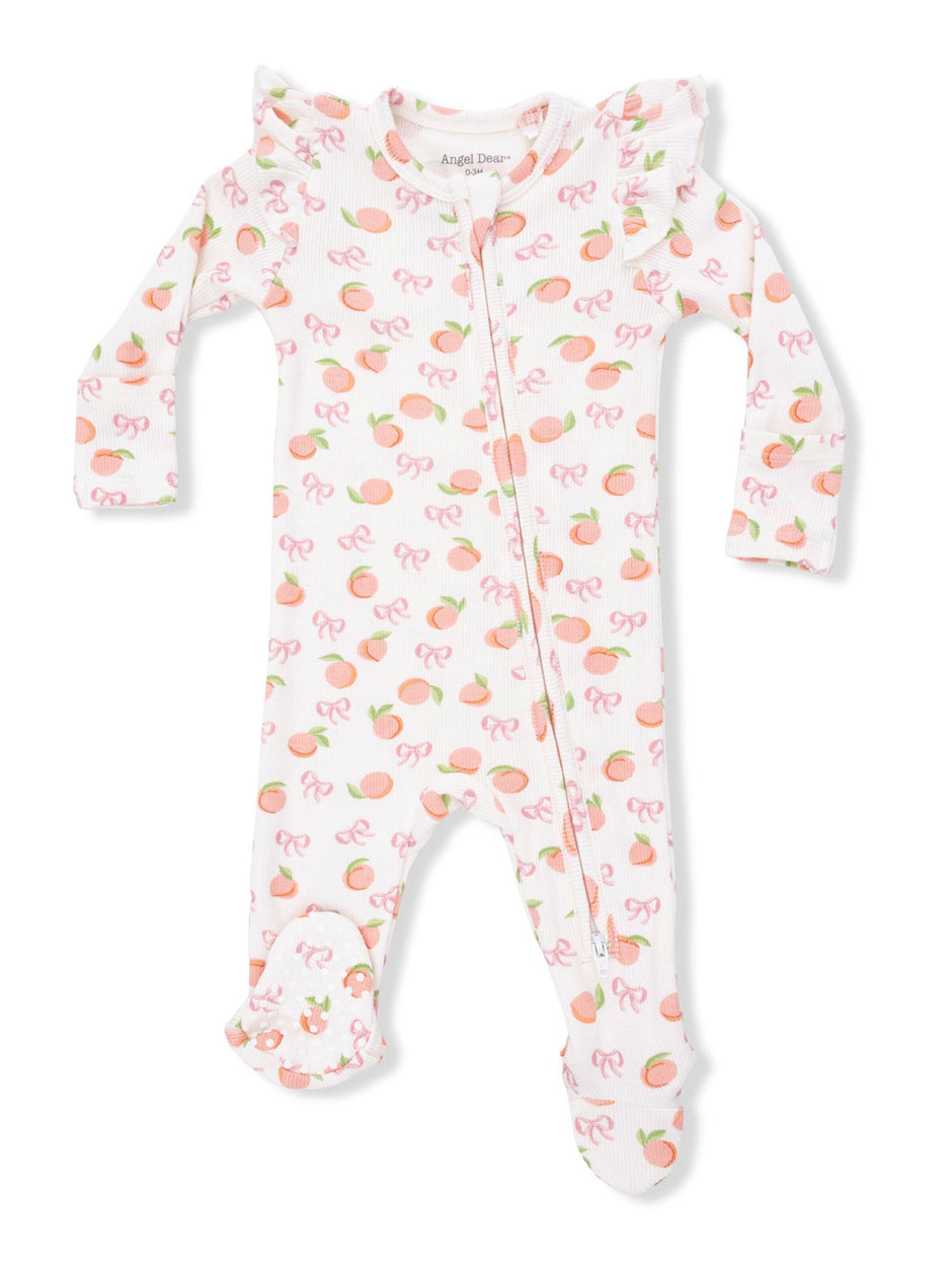 Light pink infant onesie with peach and bow patterns, featuring ruffled shoulders and footed design.