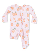 Pink baby onesie with peach pattern and zipper, featuring a polka dot pocket detail.