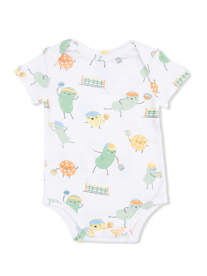White baby onesie featuring playful, cartoonish fruits and vegetables engaged in sports.