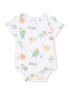 White baby onesie featuring playful, cartoonish fruits and vegetables engaged in sports.
