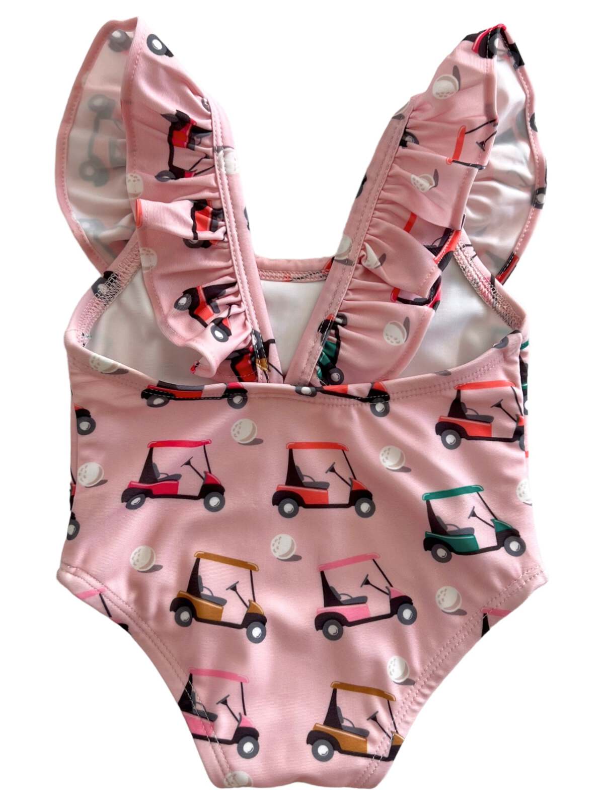 Pink swimsuit with ruffled straps and a colorful golf cart print, ideal for summer fun.