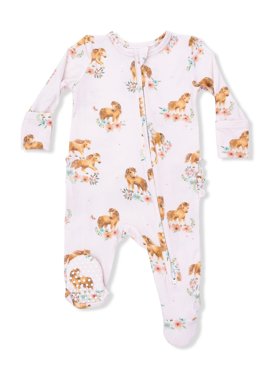 Light pink onesie with horse prints and floral accents, featuring a front zip and ruffled details on sleeves.