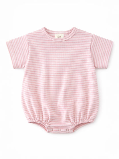 Light pink short-sleeve baby romper with a textured pattern and snap closures at the bottom.