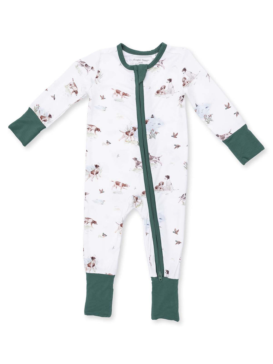 White onesie with green accents, featuring a whimsical animal print of dogs and birds, zippered front design.