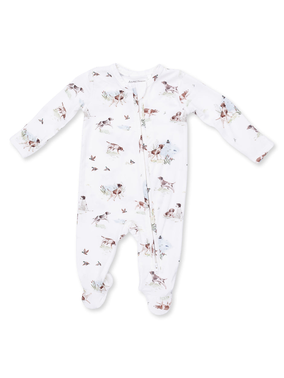 White baby onesie with dog and bird prints, featuring long sleeves and zipper closure. Perfect for comfort and style.