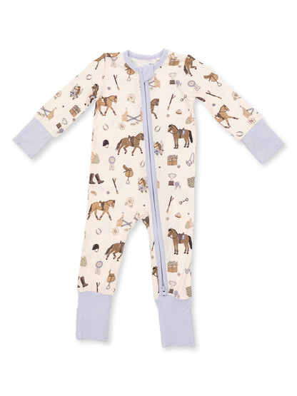 Light-colored onesie featuring horse-themed patterns and a front zipper, with lavender cuffs on the sleeves and legs.