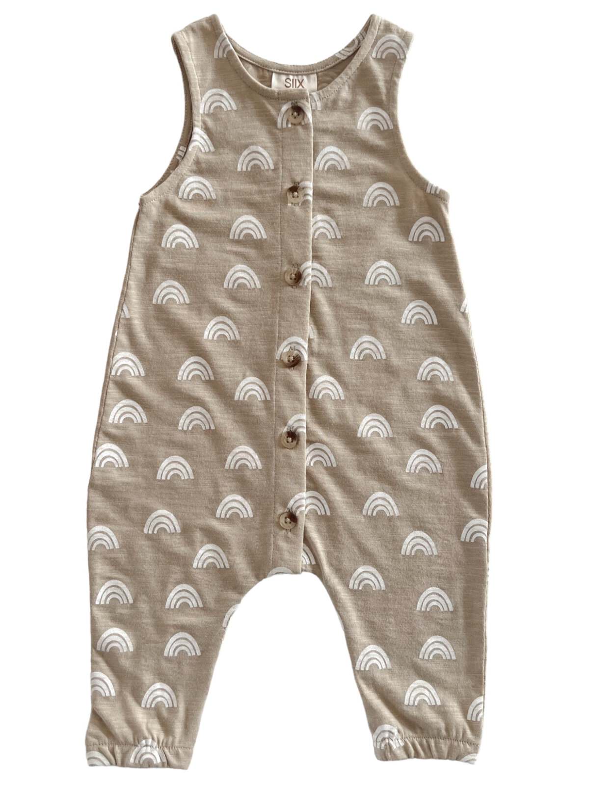 Light brown toddler romper with white rainbow patterns and wooden buttons down the front.