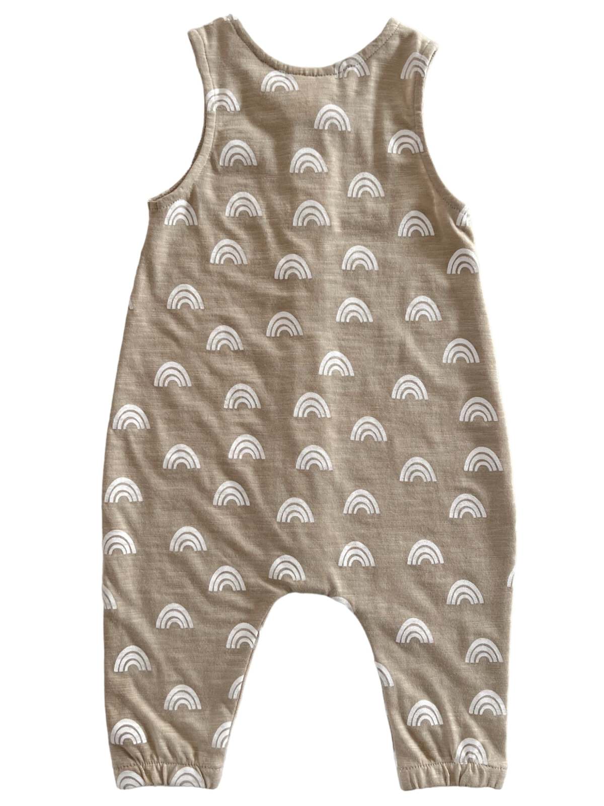 Tan baby jumpsuit with white rainbow patterns, featuring leg openings and sleeveless design. Ideal for casual wear.