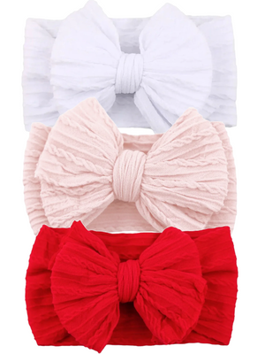 Three textured headbands in white, pink, and red with large bows, perfect for stylish hair accessories.