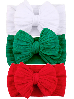 Three textured headbands in white, green, and red, featuring large bows, perfect for festive occasions.