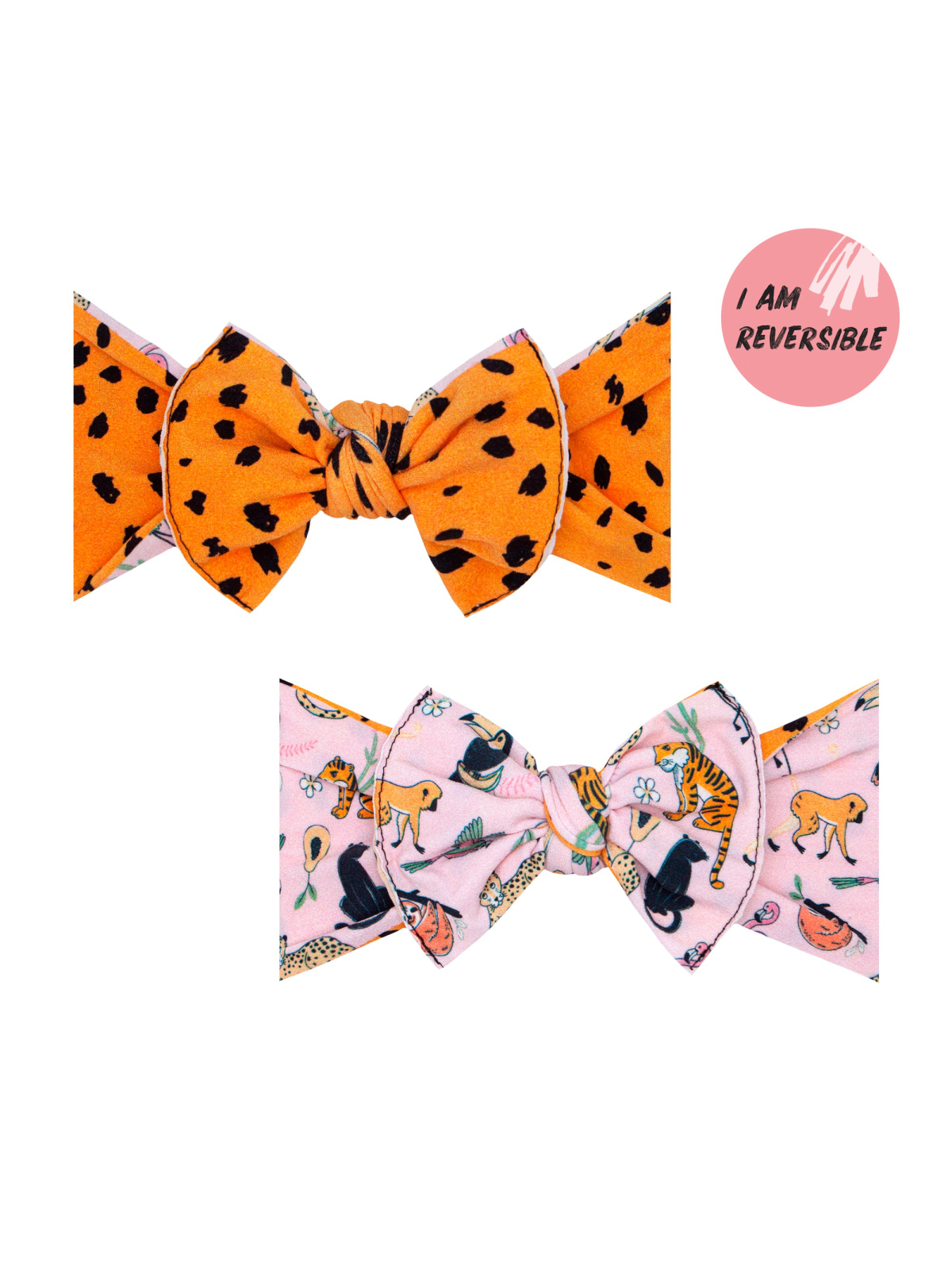 Reversible hair bow featuring orange leopard print and pink animal pattern. Perfect accessory for any outfit.