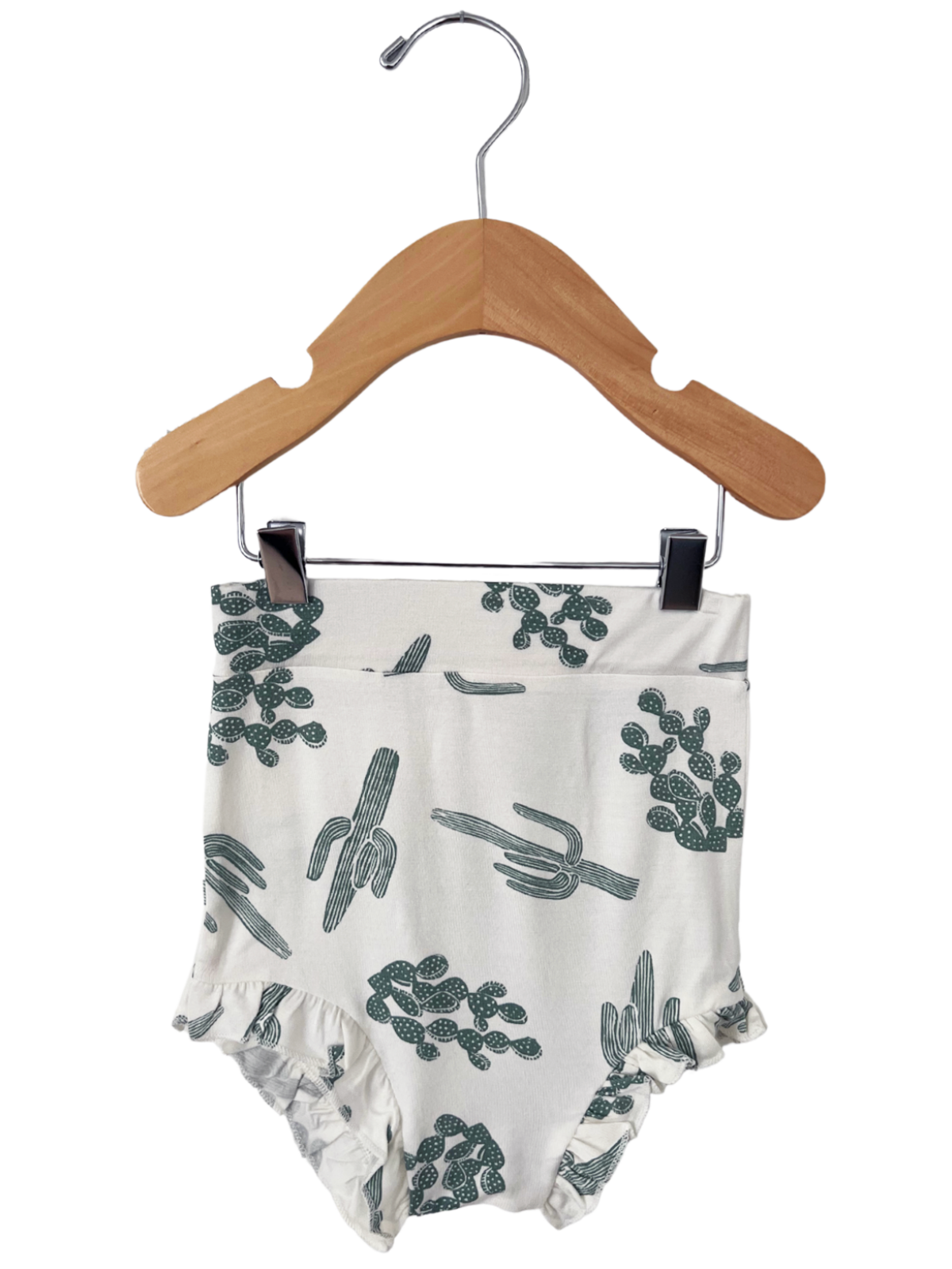 Cactus-patterned swim bottoms hanging on a wooden hanger against a white background.