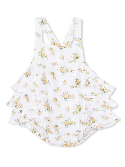 White floral romper with yellow and blue flowers, featuring ruffled layers and adjustable straps.