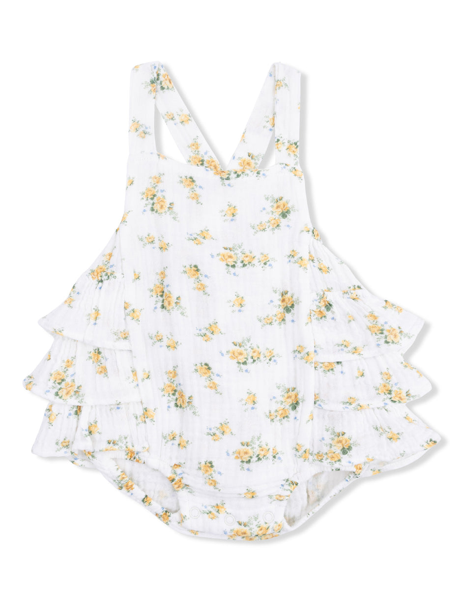 White floral romper with yellow and blue flowers, featuring ruffled layers and adjustable straps.