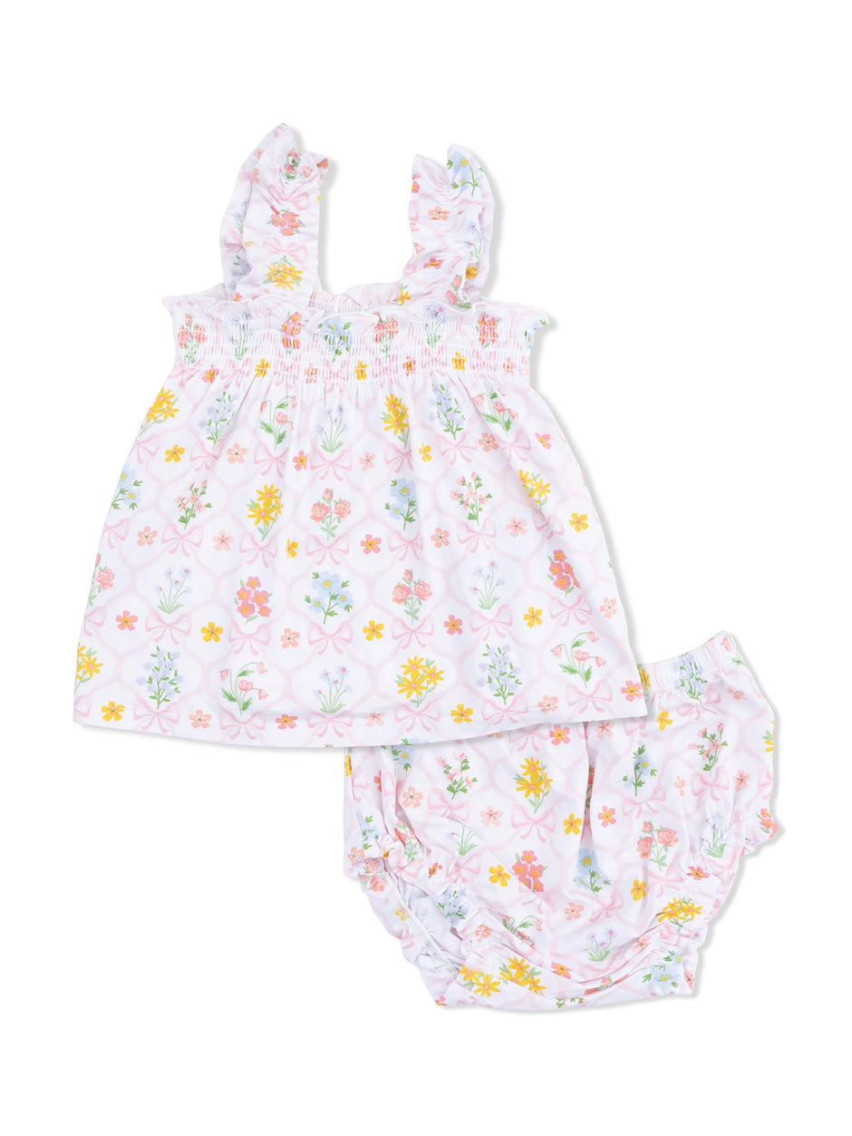 Floral baby outfit featuring a ruffled top and matching bloomers in pastel colors. Perfect for warm weather.