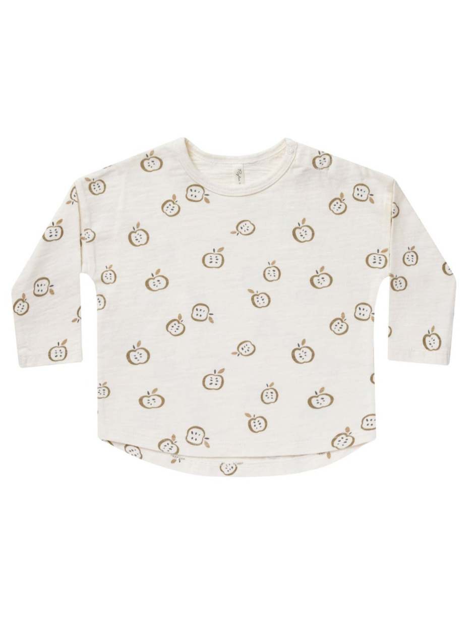 Light cream long-sleeve shirt with a playful apple print in brown and green tones.