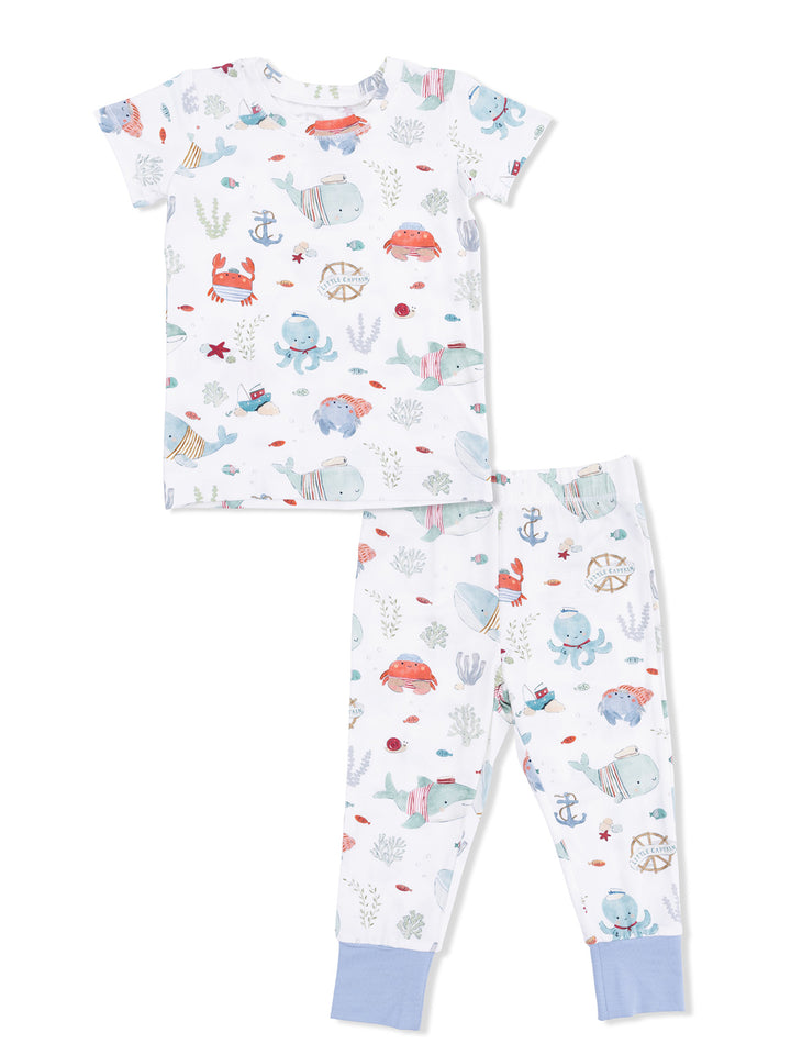 Children's pajama set featuring playful marine animal designs in soft colors, including crabs, whales, and octopuses.