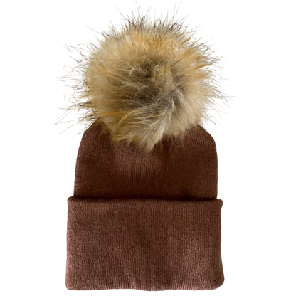 Brown knitted beanie with a fluffy tan pom-pom on top, ready for winter wear.