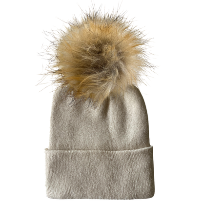 Light beige beanie hat with a fluffy beige pom-pom on top.