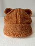 Brown bear-themed cap with fuzzy texture and ears, displayed against a white background.
